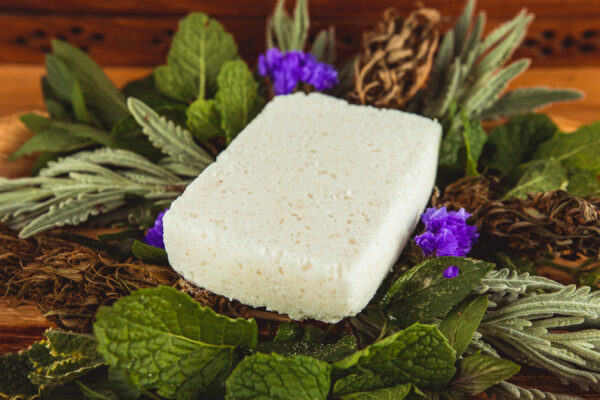 white bath bomb sitting on bed of flowers