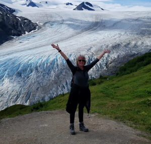 caucasian woman standing by mountain range